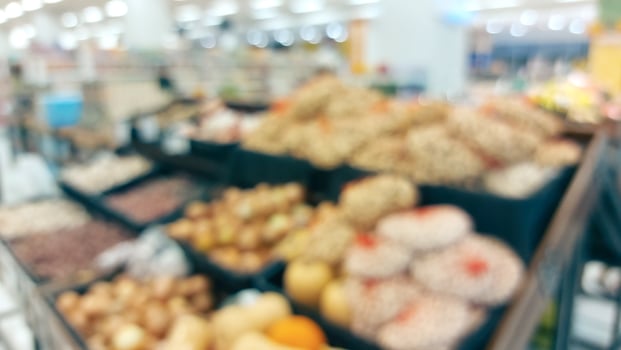 supermarket aisle and shelves blurred background. grocery store retail business concept photo