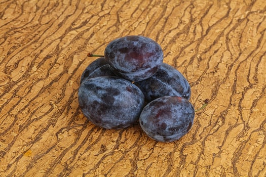 Ripe plum heap over background photo