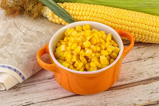 Canned yellow corn in the bowl photo