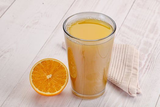 Sweet fresh orange juice in the glass photo