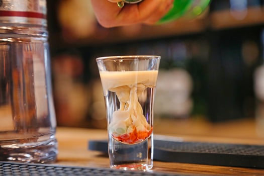 Person Pouring Refreshing Beverage Into Glass photo