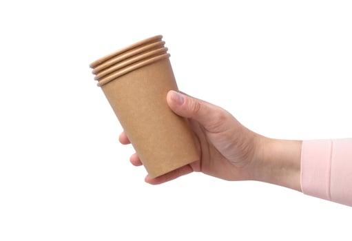 Hand hold brown paper cardboard cups on a isolated background photo