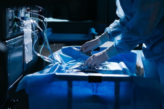 Doctor in personal protective kit Uses Medical Computer. Doctor connects wires, medical equipment, preparation before surgery in ophthalmology clinic photo