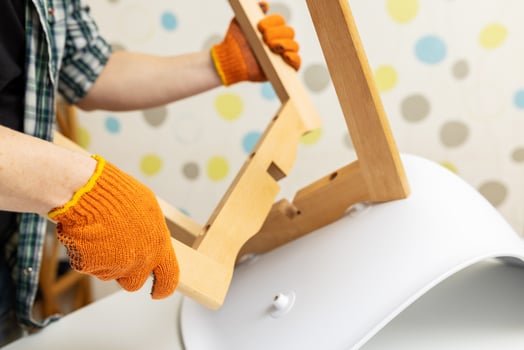 Self-assembly furniture concept. The young man himself assembling chairs photo