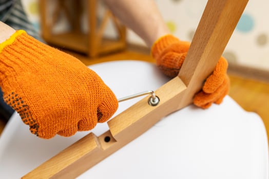 Self-assembly furniture concept. The young man himself assembling chairs photo