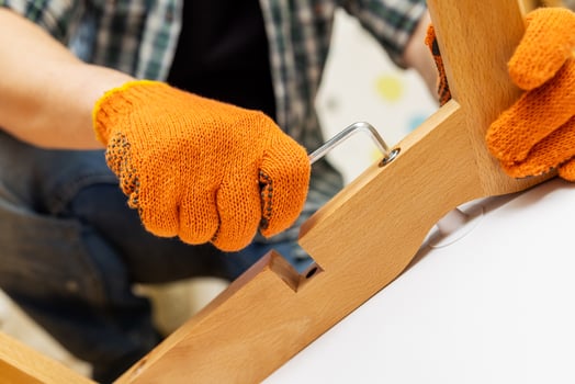 Self-assembly furniture concept. The young man himself assembling chairs photo