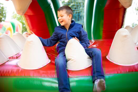 Boy Laughing on Bouncy Castle photo
