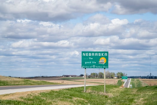 Nebraska, the good life, home of Arbor Day - roadside welcome sign at state border with Kansas, spring scenery photo
