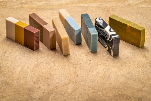 variety of 7 organic, artisan soap bars on a textured bark paper photo