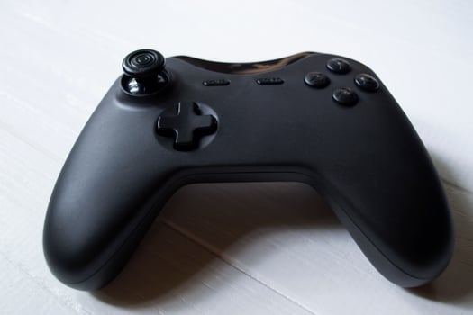 Black joystick on white table photo