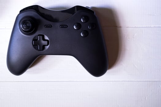 Black joystick on white table photo