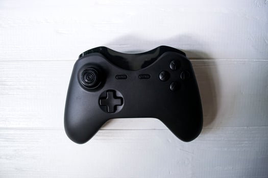 Black joystick on white table photo