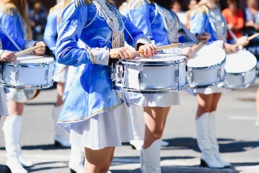 majorettes with white and blue uniforms perform in the streets of the city. photographic series photo