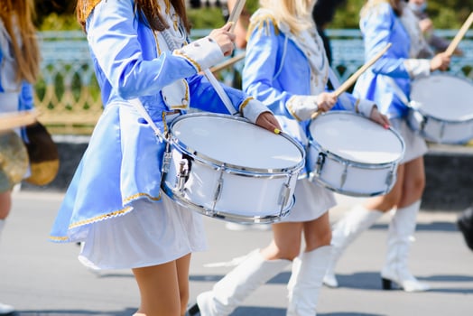majorettes with white and blue uniforms perform in the streets of the city. photographic series photo