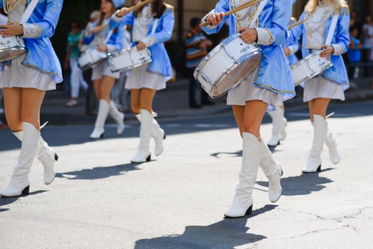 majorettes with white and blue uniforms perform in the streets of the city. photographic series photo