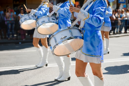 majorettes with white and blue uniforms perform in the streets of the city. photographic series photo