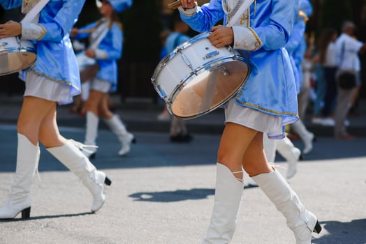 majorettes with white and blue uniforms perform in the streets of the city. photographic series photo