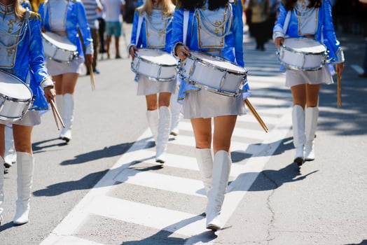 majorettes with white and blue uniforms perform in the streets of the city. photographic series photo