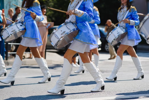 majorettes with white and blue uniforms perform in the streets of the city. photographic series photo