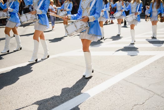 majorettes with white and blue uniforms perform in the streets of the city. photographic series photo