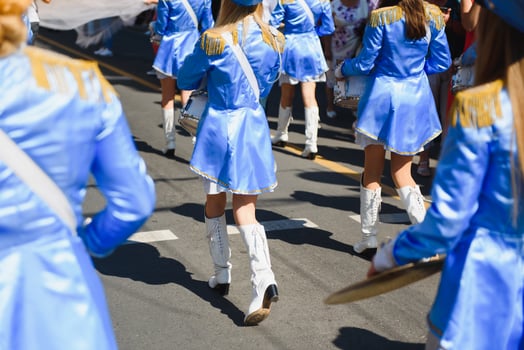 majorettes with white and blue uniforms perform in the streets of the city. photographic series photo