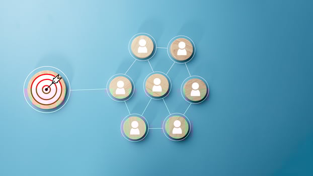 Circular wood with printed target icons and business symbols on light blue background, business goals and objectives concept, business competition, Customer relationship management concept. photo