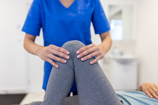 Senior patient at the physiotherapy doing physical exercises with her therapist, doing leg physiotherapy for elderly woman, to treat osteoarthritis and nerve pain in the leg. photo