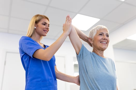 Doctor or Physiotherapist working examining treating injured arm of senior female patient, stretching and exercise, Doing the Rehabilitation therapy pain in clinic. photo