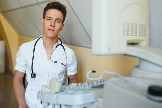 Sonographer operating modern ultrasound machine in clinic photo