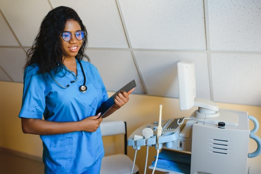 pretty female african medical nurse holding clipboard photo