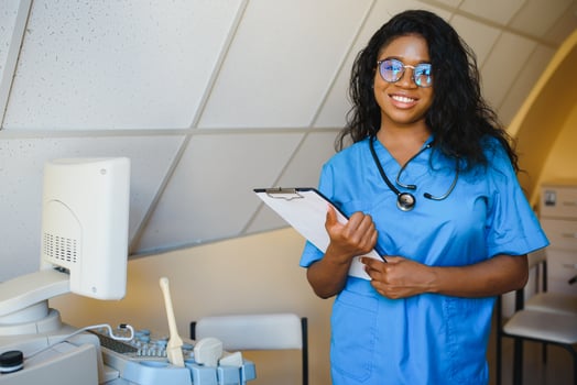 pretty female african medical nurse holding clipboard photo