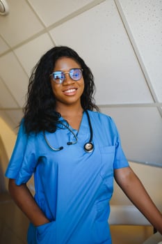 pretty female african doctor with arms crossed at hospital photo