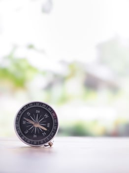 Close up compass on table in the sunset time. The concept of world tourism day, Searching the right directions and Travel photo
