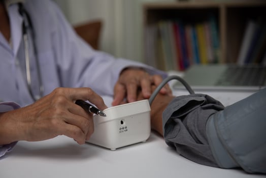 healthcare professional checking a patient's blood pressure, a vital step in medical assessment and patient care. photo