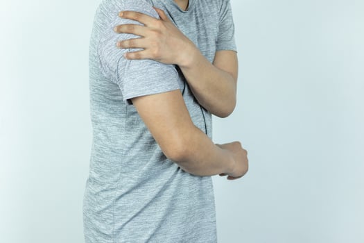 Man suffering from shoulder pain on white background photo