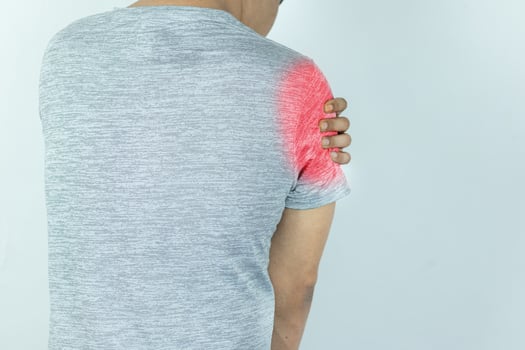 Man suffering from shoulder pain on white background photo