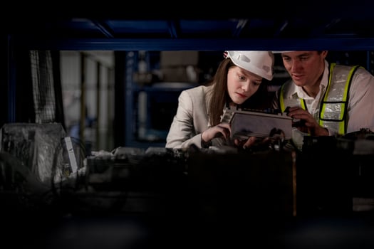 checking and inspecting metal machine part items for shipping. male and woman worker checking the store factory. industry factory warehouse. The warehouse of spare part for machinery and vehicles. photo