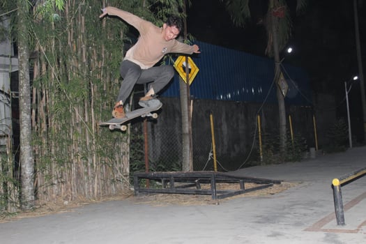 Indonesia - Medan 01 August 2023 an asian man doing skateboard tricks on a ramp photo