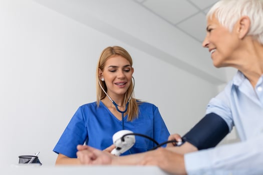 Measuring blood pressure. Senior woman have a visit with female doctor in modern clinic. Measuring blood pressure. Pressure gauge. Hypertension and high heart rate photo
