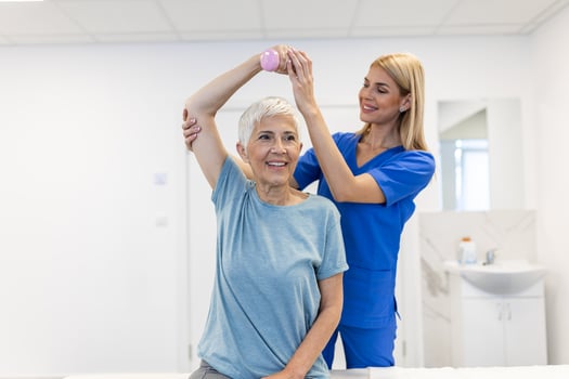 Doctor or Physiotherapist working examining treating injured arm of senior female patient, stretching and exercise, Doing the Rehabilitation therapy pain in clinic. photo