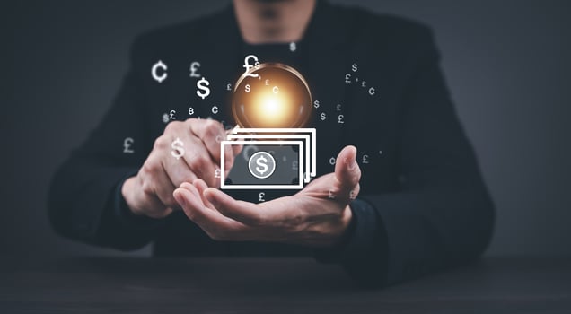 Businessman holding virtual bank with currency sign for forex exchange and global money transfer by technology concept. photo