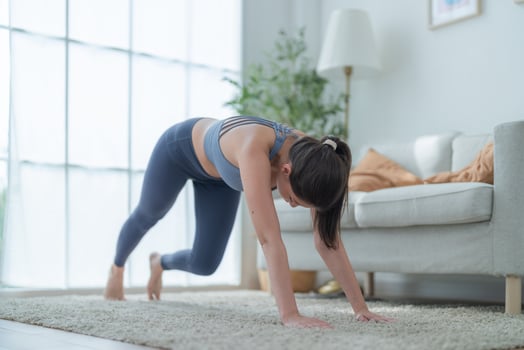 Two women confident training yoga. Athletic women in sportswear doing fitness stretching exercises at home in the living room. Sport and recreation concept. Yoga teacher is helping young woman. photo