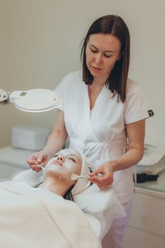 Cosmetologist esthetician performs skin treatment and rejuvenation photo