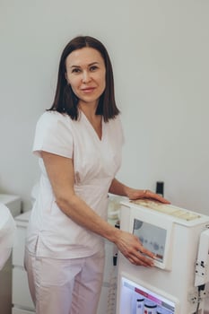 Cosmetologist esthetician performs skin treatment and rejuvenation photo