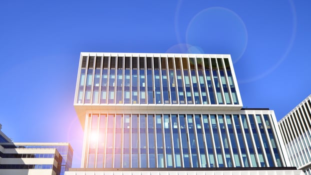 Modern office building in the city with windows and steel and aluminum panels wall. Contemporary commercial architecture, vertical converging geometric lines. photo
