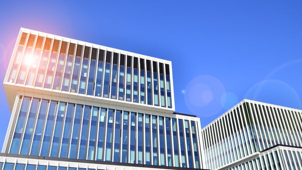 Modern office building in the city with windows and steel and aluminum panels wall. Contemporary commercial architecture, vertical converging geometric lines. photo