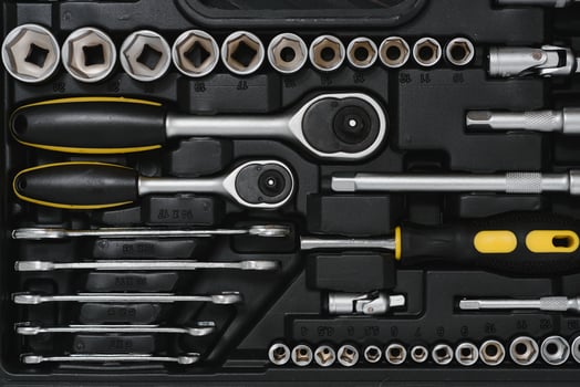 New square black tool box on wooden texture background. Top view. photo