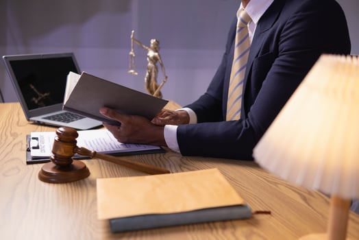 young lawyer was flipping through Bible in his legal office just to learn about God teachings from the Bible and to be reminded to do what is right. The concept of belief and the power of faith in God photo