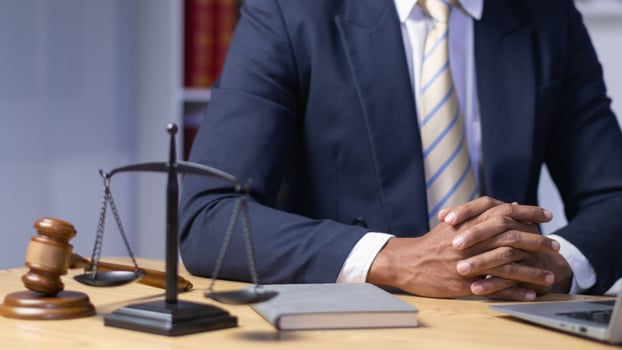 lawyer used his hands together as sign to pray to God based on his faith and power of faith in God and to pray that he would be able to win case based on the evidence and information gathered. photo