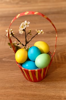 Paint eggs for Easter, bright Easter holiday, children paint eggs, colored eggs in a basket, colored eggs on a stand, Holiday background photo